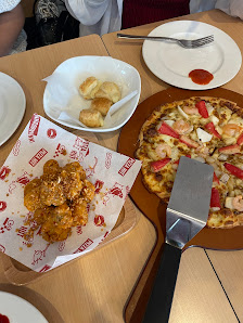A variety of dishes including fried chicken wings and pizza