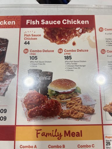 The image is a menu board from a restaurant in Thao Dien, Saigon. It features sections like 'Fish Sauce Chicken' with prices (e.g., Fish Sauce Chicken
