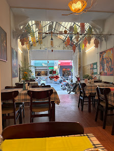 The image shows an interior view of a restaurant or cafe in Thao Dien, Saigon. The space is well-lit with natural light coming through the skylights a