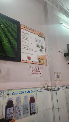 The image shows an interior view of a restaurant or cafe in Thao Dien, Saigon with various signs and advertisements on the wall.