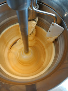 A close-up view of a food preparation process in what appears to be a commercial kitchen setting.