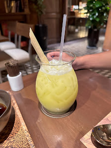 A close-up of a yellow drink in a glass jar on a table at Thao Dien, Saigon.