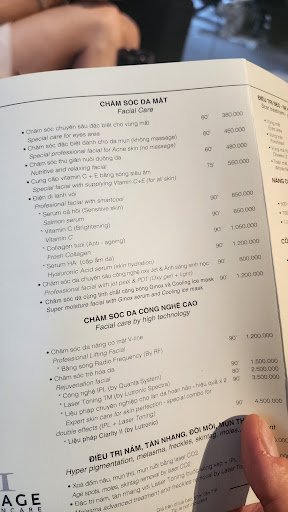A person is holding a menu from Cham Soc Da Mat Facial Care in Thao Dien, Saigon.