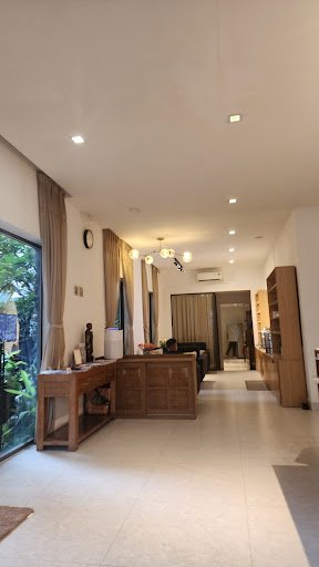 This image shows a well-lit interior space that appears modern and clean. The flooring is light-colored tiles, and the walls are painted in neutral to
