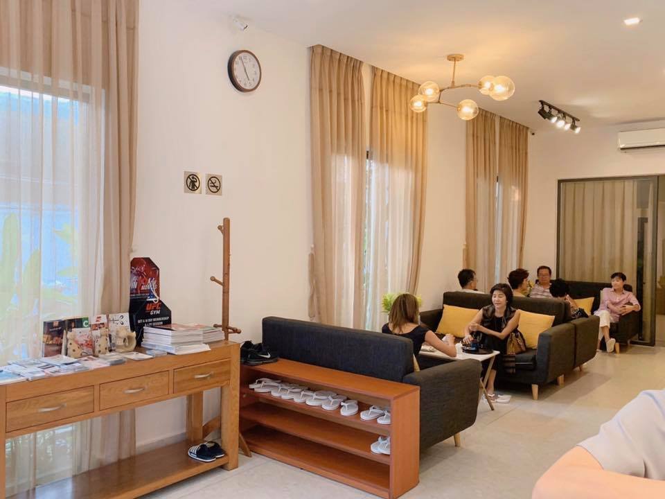 The image depicts a spacious, well-lit interior space, likely a lounge or waiting area in a venue in Thao Dien, Saigon. The room features light-colore