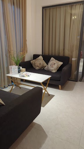 The image shows a modern living room or waiting area in an establishment located at Thao Dien, Saigon.