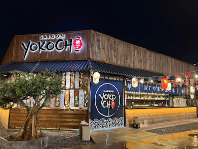 The image shows an exterior view of a restaurant named 'Saigon Yokoch' with traditional Japanese-style decor and signage in English and Vietnamese.