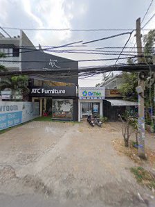 The image shows an exterior view of a commercial building named 'ATC Furniture' with other businesses visible in the background.