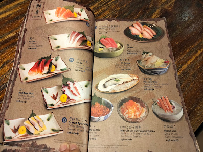 A menu from a restaurant in Thao Dien, Saigon showcasing various Japanese dishes such as sashimi and sushi.