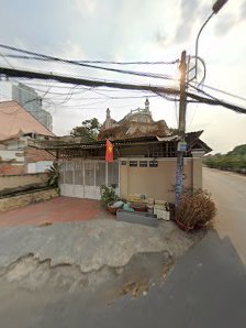 The image depicts a street view of an exterior scene in Thao Dien, Saigon. There is a building with what appears to be religious significance on top a