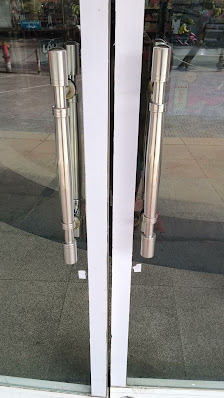 The image shows a close-up of the entrance doors of what appears to be an establishment in Thao Dien, Saigon.