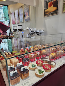 The image shows a display case in an interior setting of Thao Dien, Saigon filled with various pastries and desserts on sale.