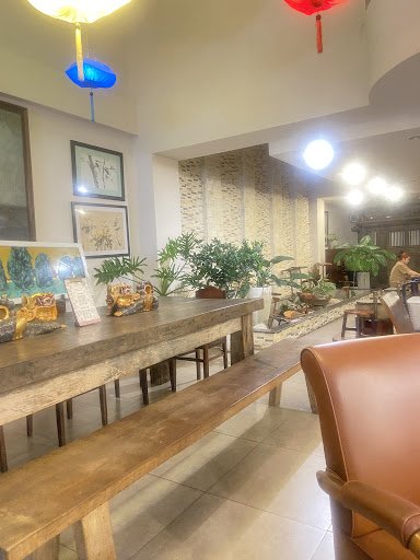 The image depicts an interior space that appears to be a living or dining area in Thao Dien, Saigon. The room is well-lit with natural light complemen