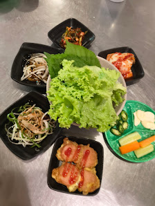 Various Korean dishes including wraps and side items.