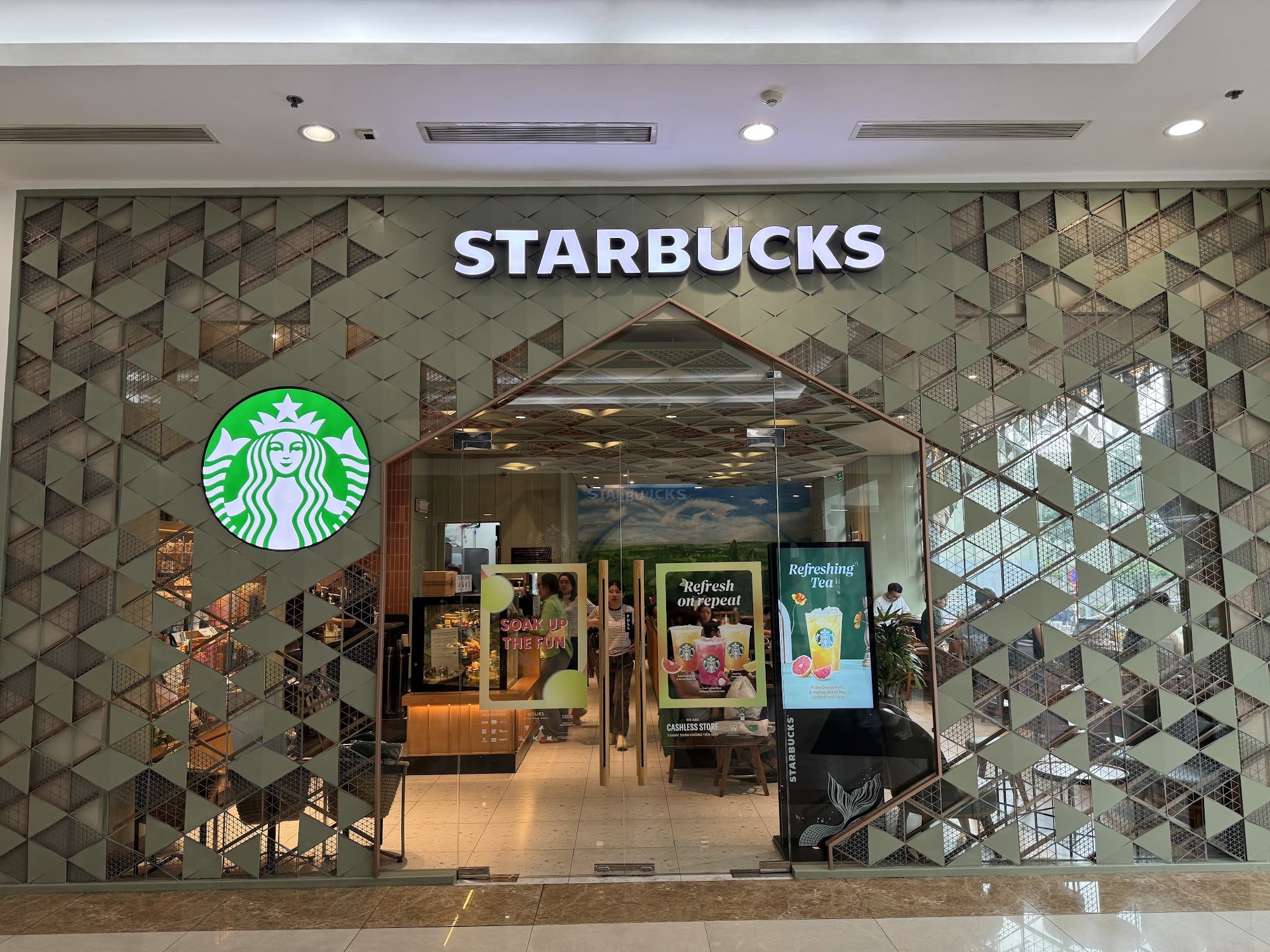 The image shows an exterior view of a Starbucks store located in Thao Dien, Saigon.