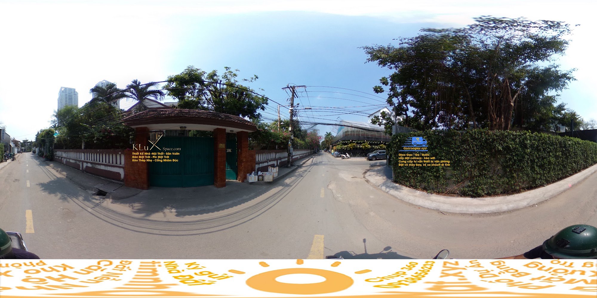 The image shows a panoramic view of an urban street scene in Thao Dien, Saigon. It features a green entrance gate with signage and text indicating it