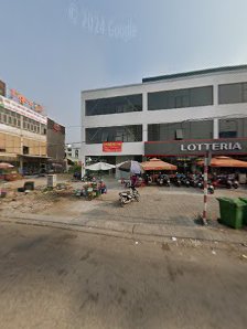The image depicts an outdoor urban scene in Thao Dien, Saigon. It features a multi-story building with commercial establishments on the ground floor,