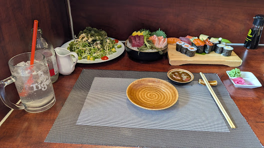 The image depicts a dining table setup in a restaurant located in Thao Dien, Saigon. The table features a gray placemat with a yellow ceramic bowl at