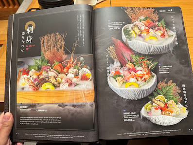 The image shows a menu from Thao Dien, Saigon featuring various dishes presented in bowls with garnishes and ingredients visible.