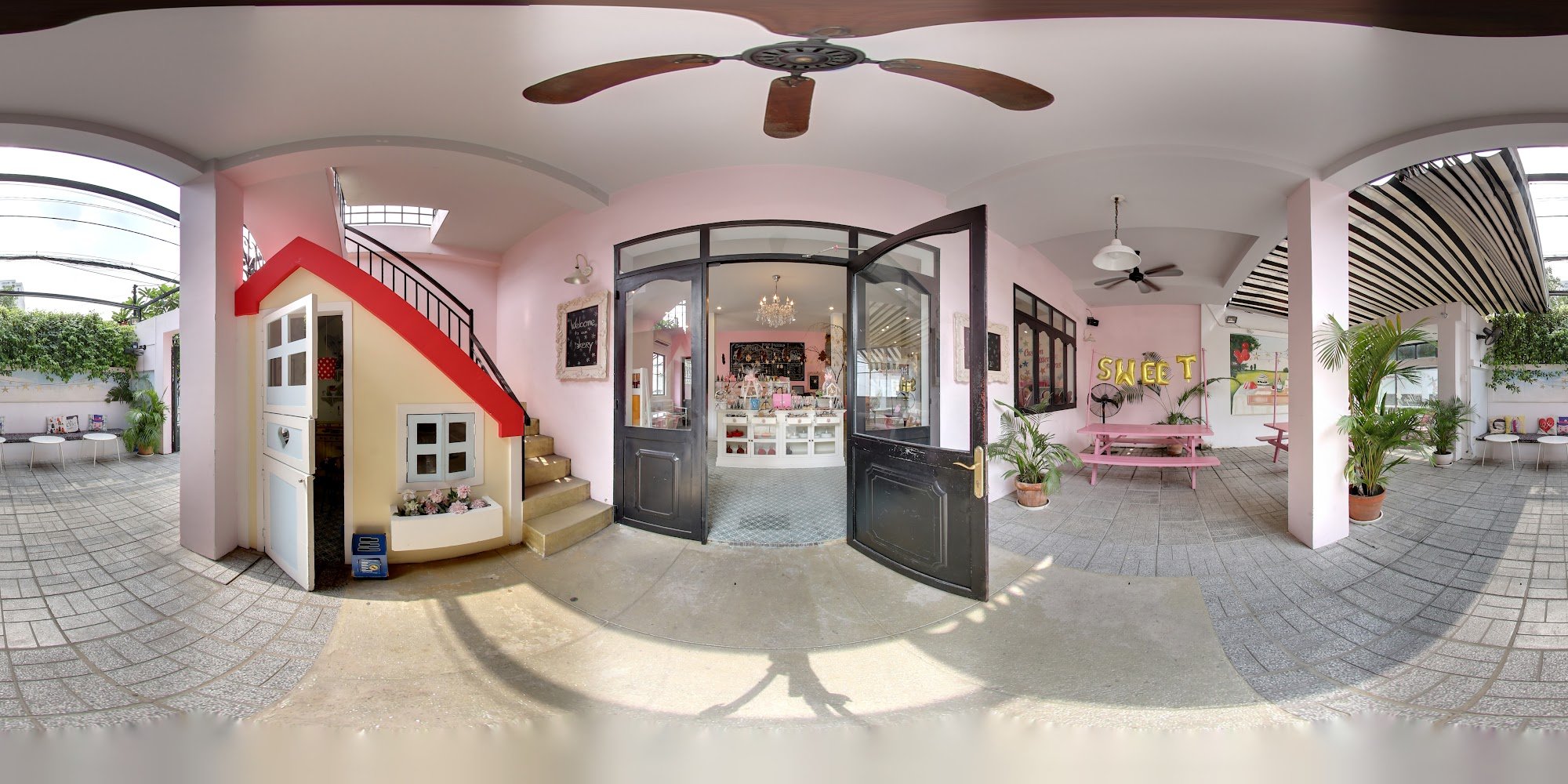 This image shows an interior space of a boutique or shop located in Thao Dien, Saigon. The area is well-lit with natural light coming through the larg
