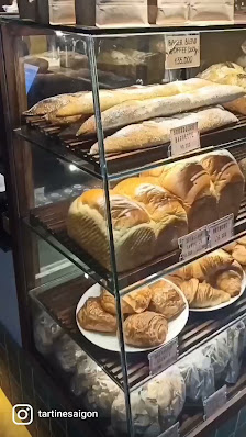 A bakery display case showcasing an assortment of bread and pastries.
