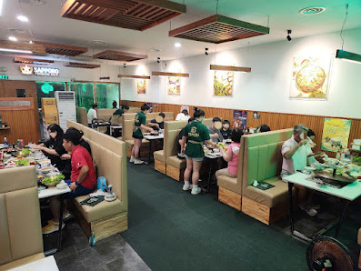 The image shows an interior view of a restaurant named 'Hai Phong' with multiple dining booths and tables occupied by patrons enjoying their meals.
