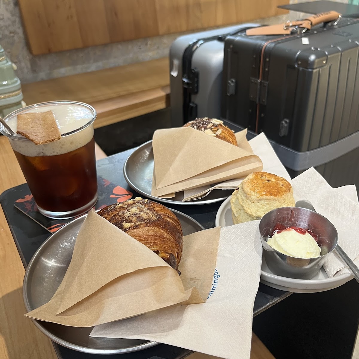 The image shows a table set for two people in what appears to be an indoor setting with wooden elements and modern decor, possibly within Thao Dien, S