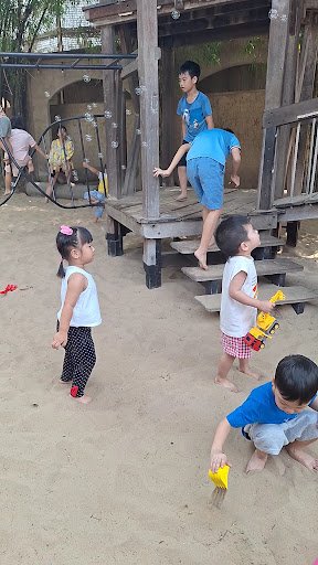 Children playing on a playground structure in an outdoor area of Thao Dien, Saigon.