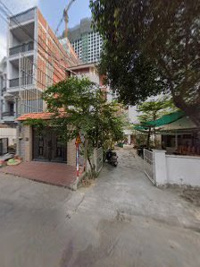 The image shows a street view of an urban area in Thao Dien, Saigon with buildings and parked motorcycles on the side.