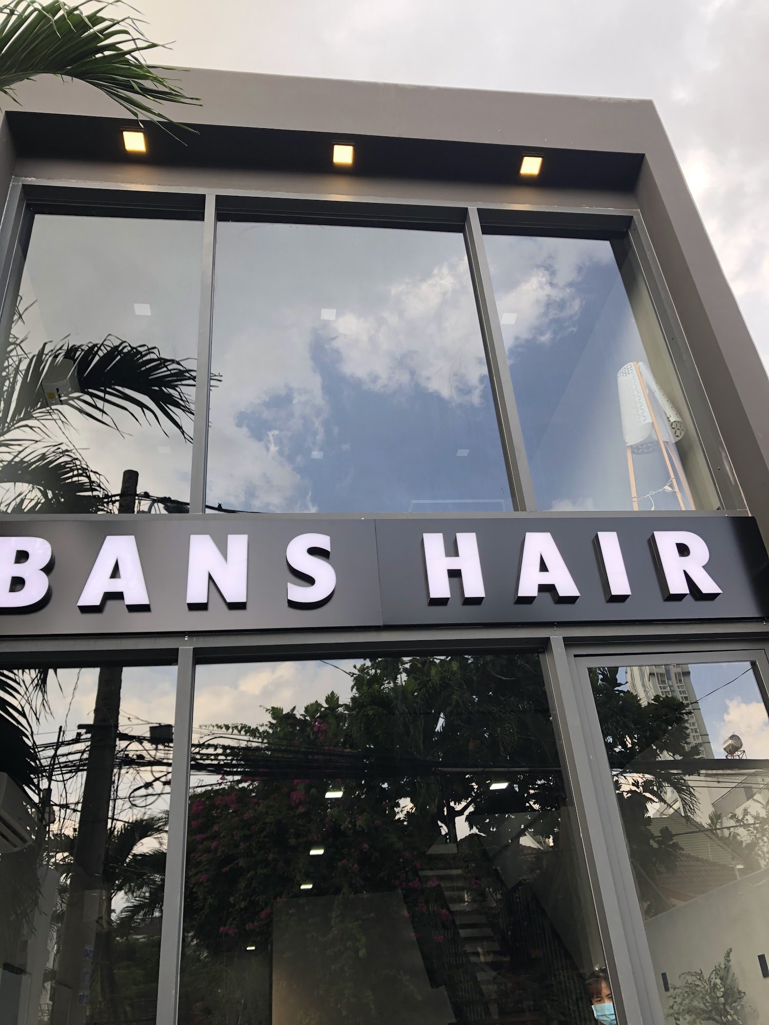 The image shows a storefront of 'BANS HAIR', which appears to be a hair salon located in Thao Dien, Saigon.