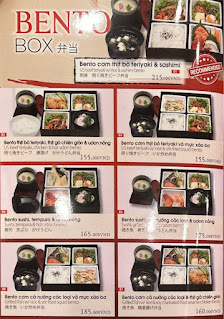 The image is a menu for Bento Box offerings at a venue in Thao Dien, Saigon. It features multiple bento box options with images, descriptions in Engli