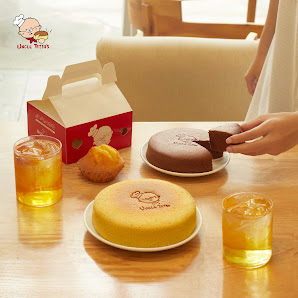 The image shows a dining table set in an interior space that appears to be part of a restaurant or cafe named 'Cafe Tru Buoi'. On the table, there are