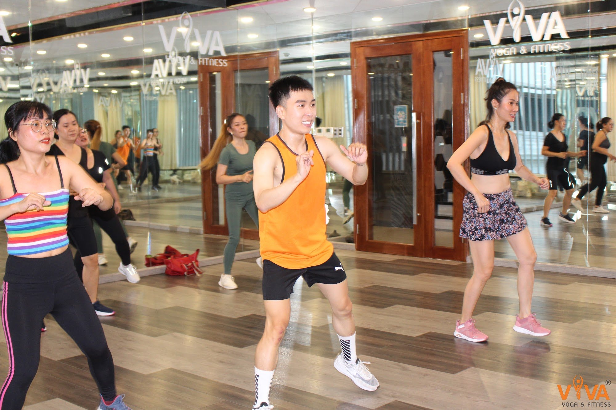 A group of people is participating in a fitness class at VIVA Yoga & Fitness studio located in Thao Dien, Saigon.
