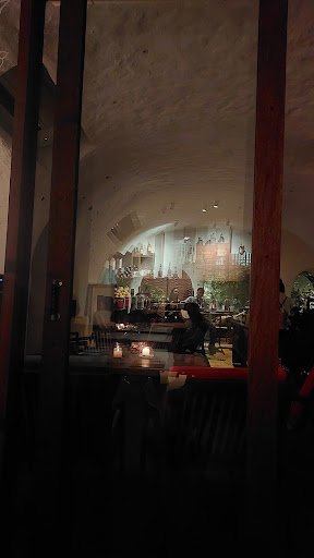 The image shows an indoor setting that appears to be a restaurant or café in Thao Dien, Saigon. The interior has warm lighting and features wooden bea
