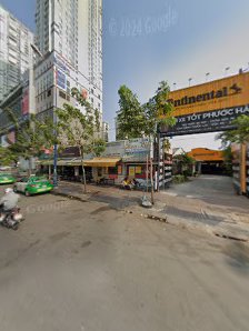 The image shows an exterior view of a commercial area in Thao Dien, Saigon with various shops and signage visible.
