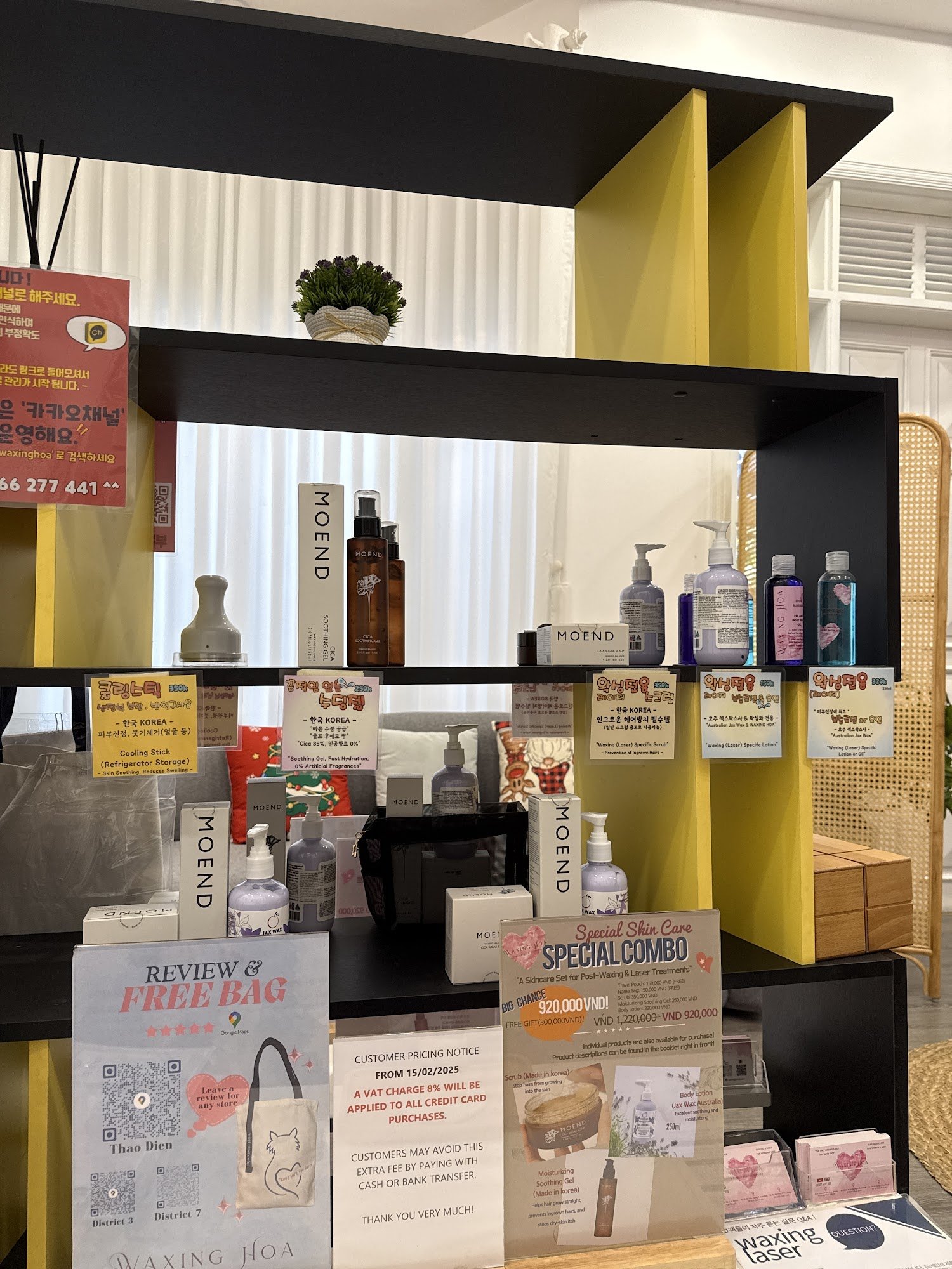 The image depicts the interior of a beauty store in Thao Dien, Saigon. It features black and yellow shelving units displaying various skincare and hai