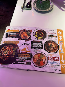 A menu displayed on a table at Thao Dien in Saigon featuring various dishes and their prices.