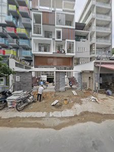 The image shows a construction site in Thao Dien, Saigon, featuring multi-story residential buildings with various balconies and windows.